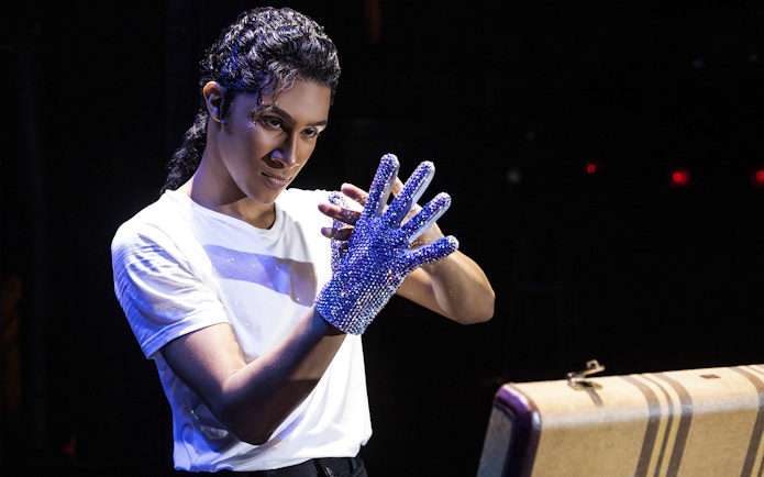 Performer wearing a sequined glove at MJ Live tribute concert.