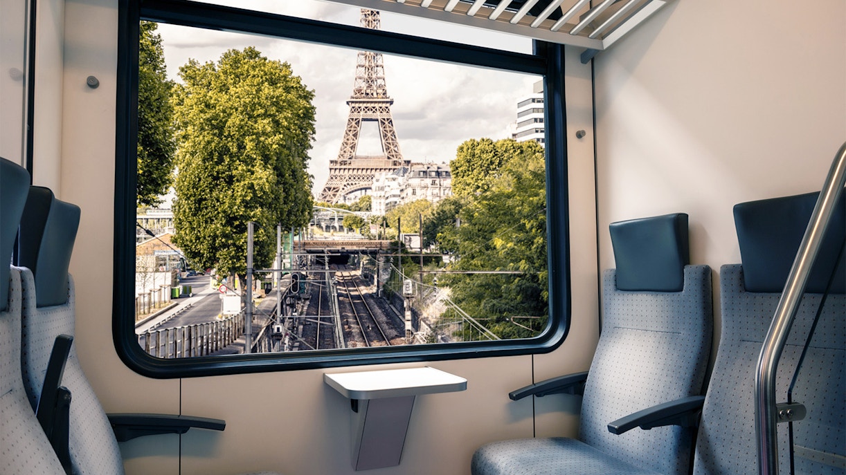 View of Eiffel Tower from train window in Paris near Army Museum.