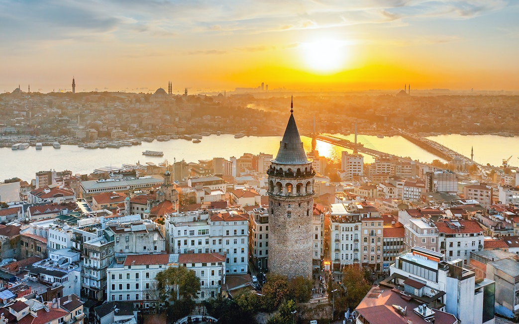 Galata Tower overlooking Istanbul skyline at sunset, Turkey.