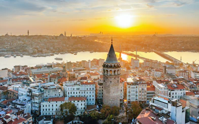 Galata Tower overlooking Istanbul skyline at sunset, Turkey.