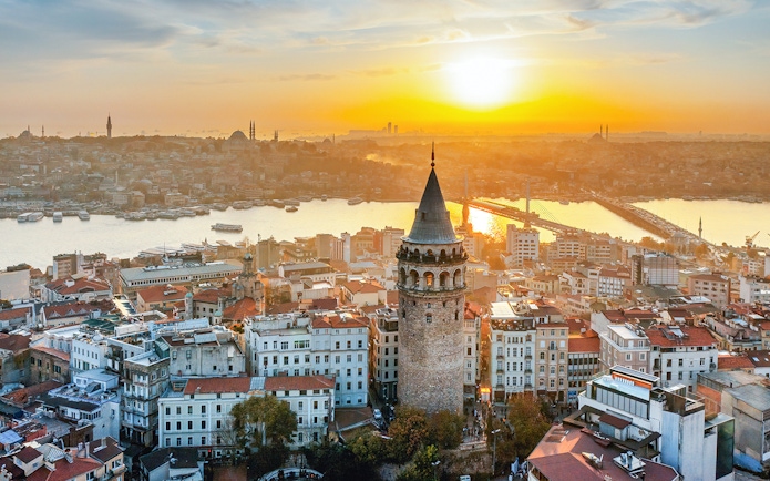 Galata Tower overlooking Istanbul skyline at sunset, Turkey.