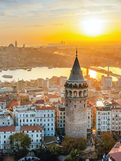Galata Tower overlooking Istanbul skyline at sunset, Turkey.