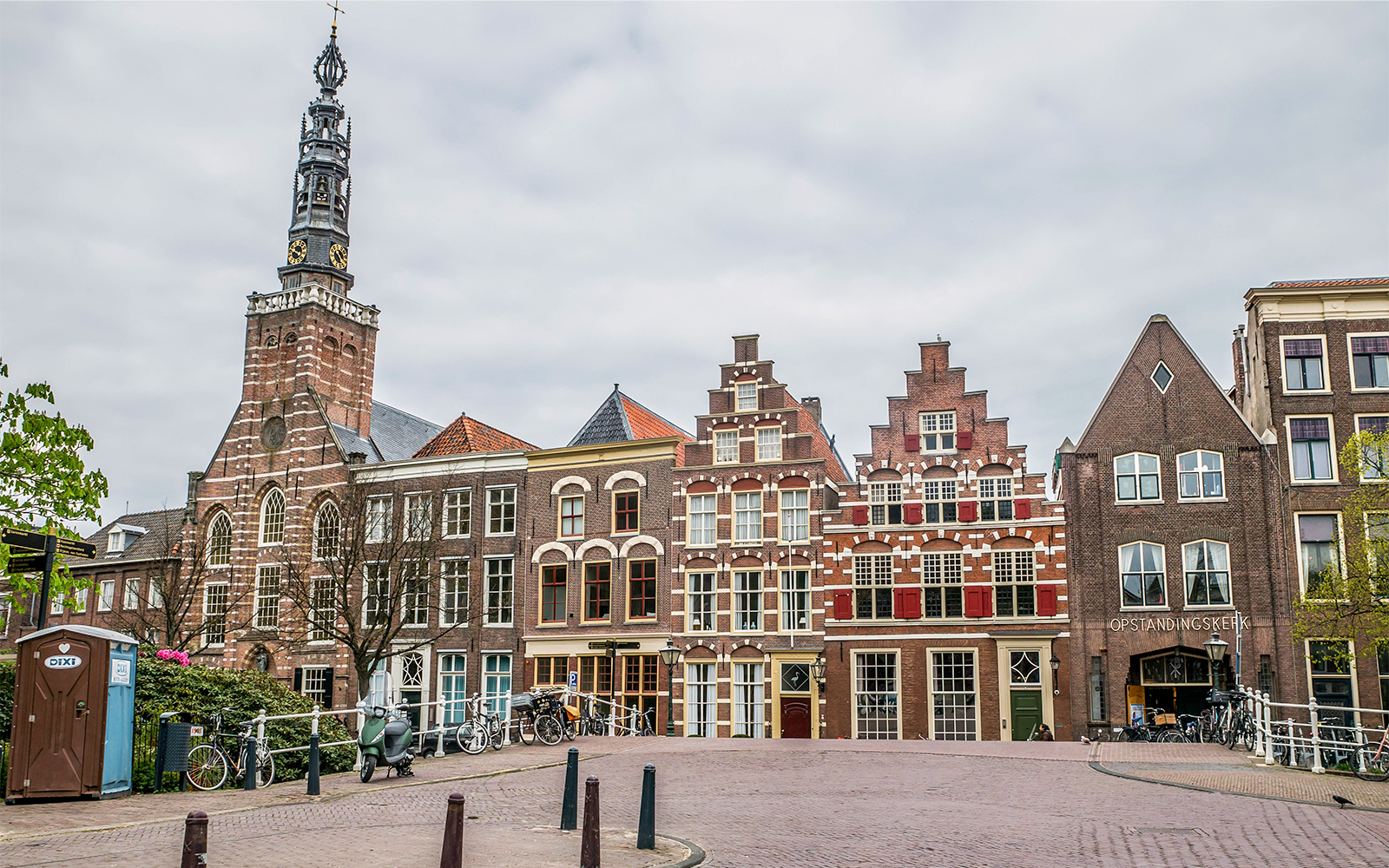 Canal view with traditional Dutch houses and boats in Leiden, Netherlands.