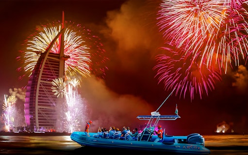 Speedboat near Burj Al Arab with New Year fireworks in Dubai.