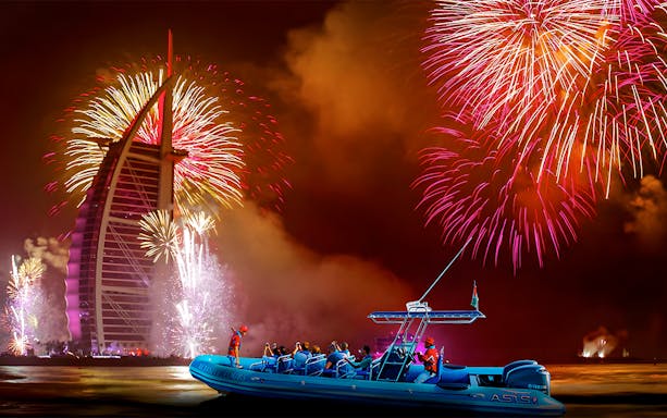 Speedboat near Burj Al Arab with New Year fireworks in Dubai.