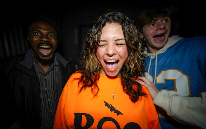 Guests reacting in Halloween Haunt zones at Dorney Park.