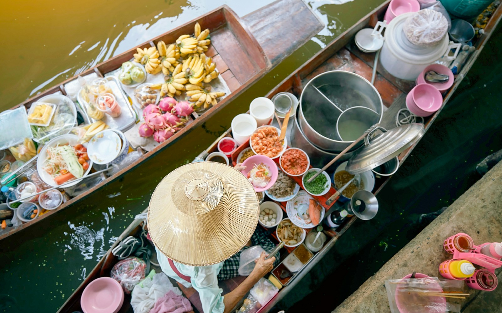 Vendor on boat in Damnoen Saduak floating market, Bangkok