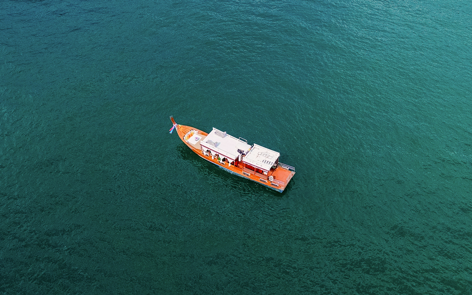 Long-tail boat on clear waters en route to Ko Hong, Thailand.