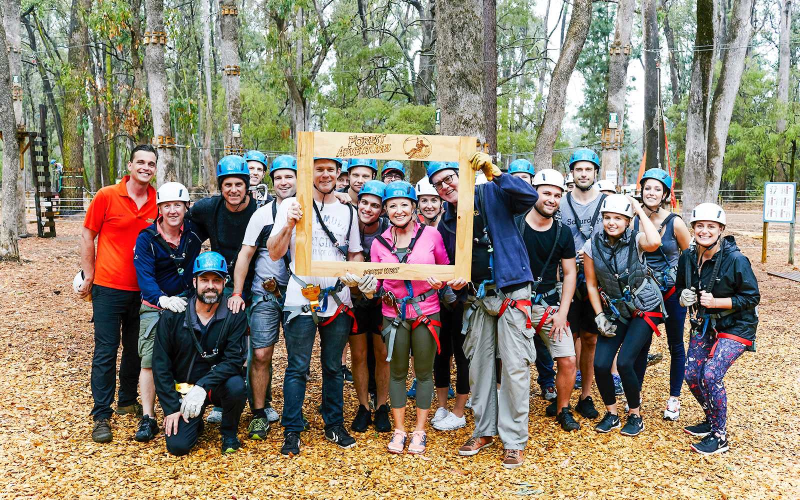 Group of people in helmets and harnesses at Ludlow Tuart Forest zipline, Western Australia.