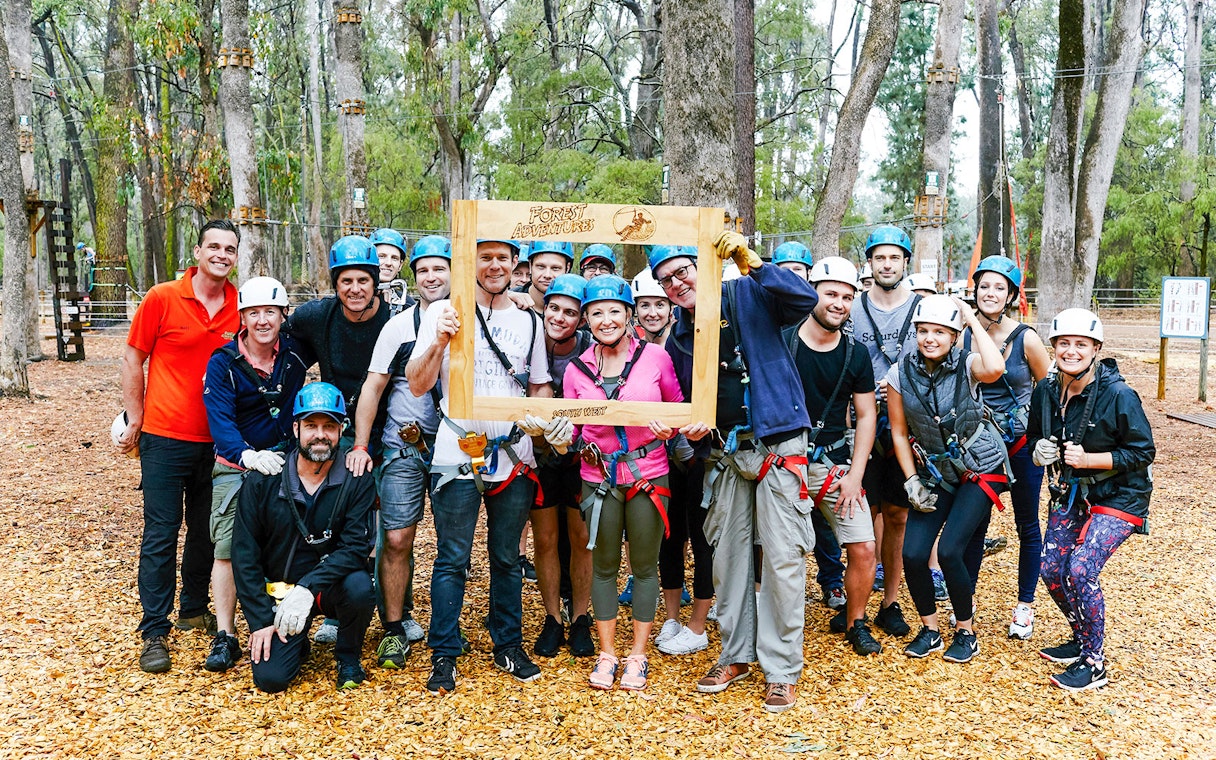 Group of people in helmets and harnesses at Ludlow Tuart Forest zipline, Western Australia.