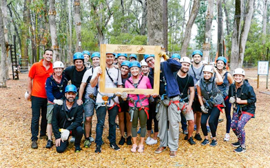 Group of people in helmets and harnesses at Ludlow Tuart Forest zipline, Western Australia.