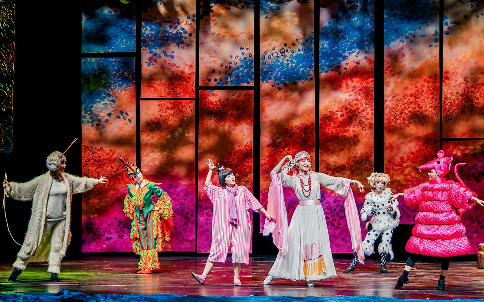 Performers in colorful costumes on stage during The Dragon Child show, Sydney.