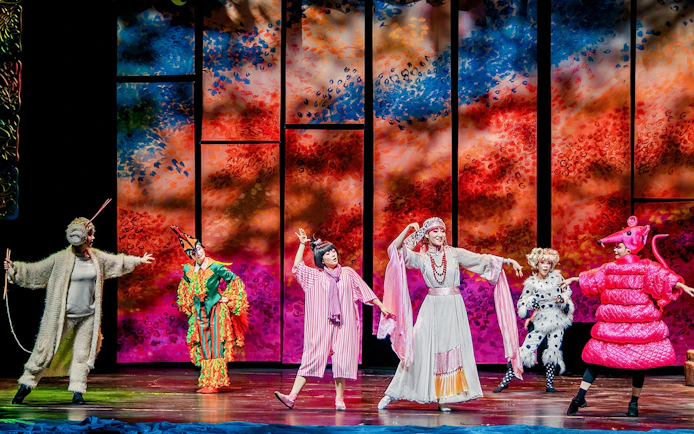 Performers in colorful costumes on stage during The Dragon Child show, Sydney.