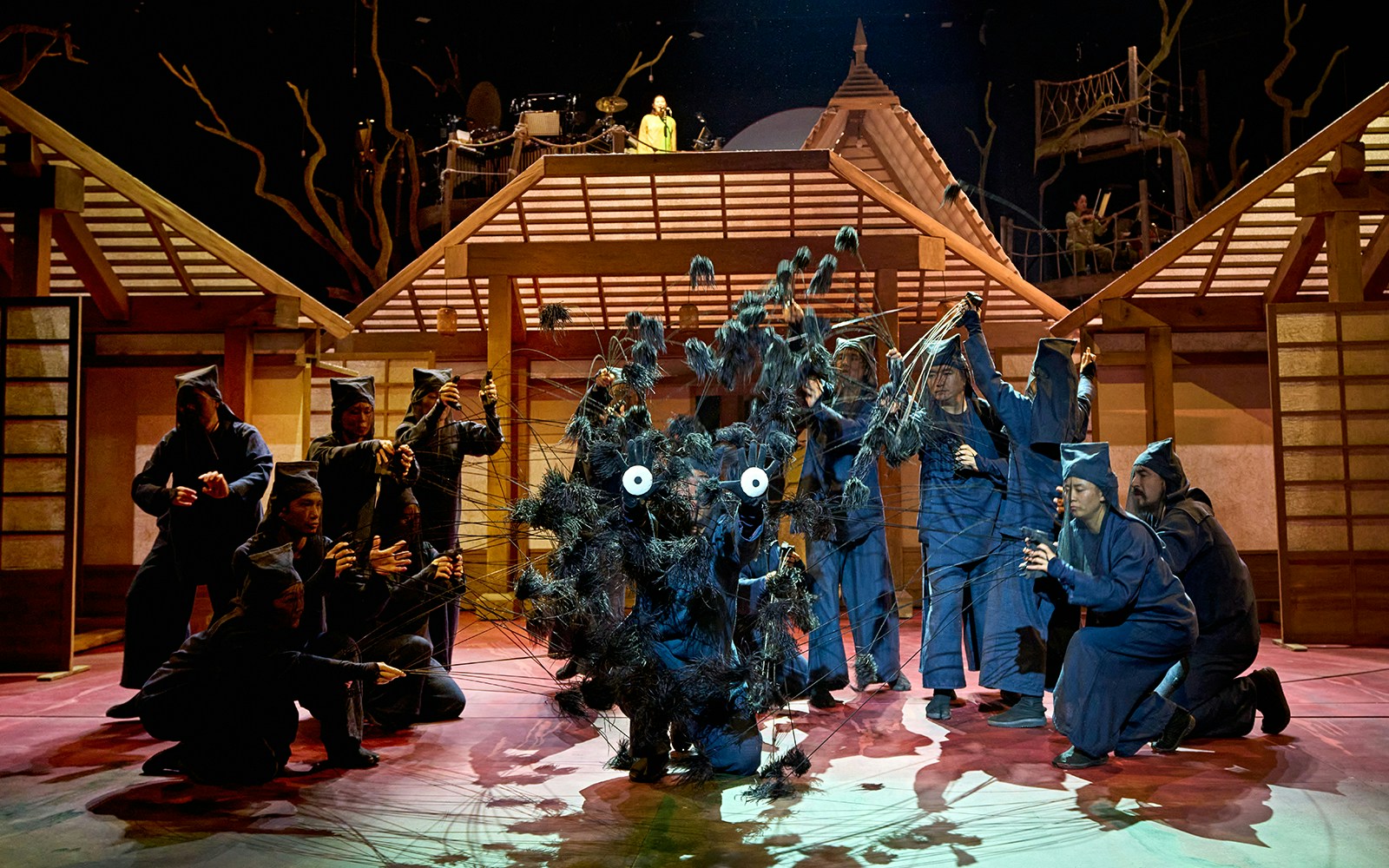 Stage performance of My Neighbour Totoro with actors in traditional Japanese setting.