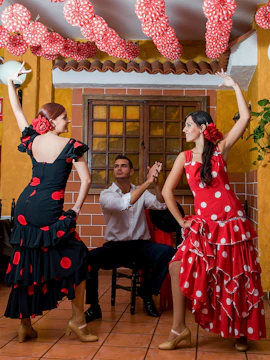 Flamenco dancers performing in a traditional Granada setting.