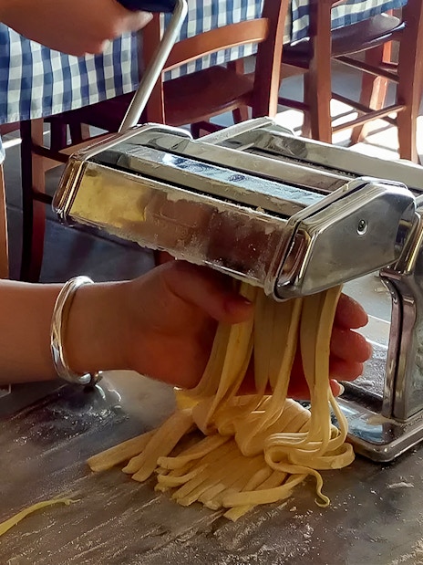 Making fresh pasta with a machine during Amalfi Coast cooking class.