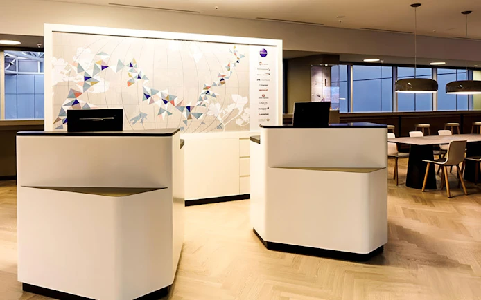 Reception area of Aspire ONE Lounge at Zurich Airport, featuring modern decor and seating.