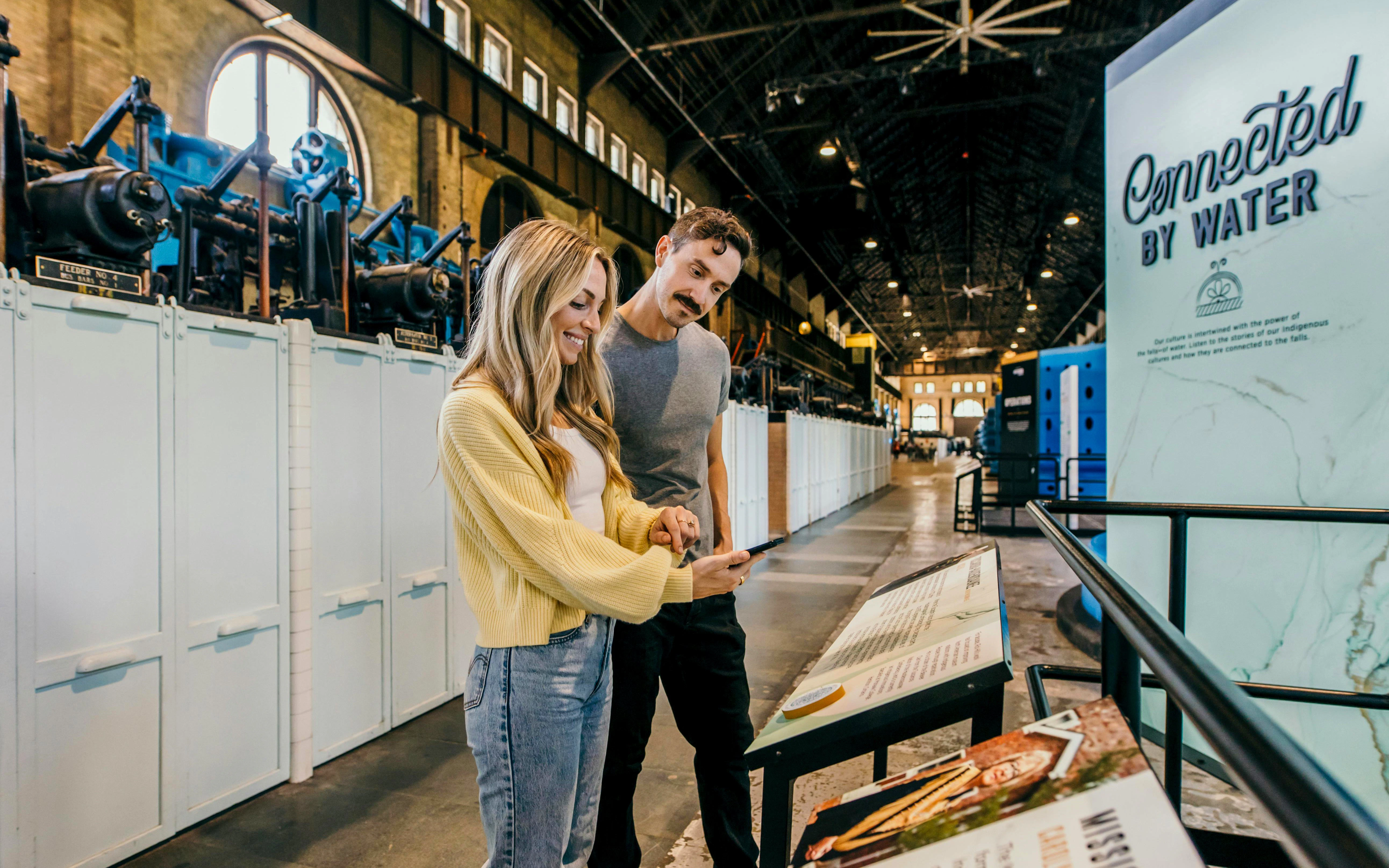 Visitors exploring exhibits inside a historic power station.