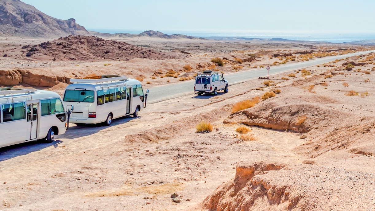 Minibuses parked at Ras Mohamed National Park, Sharm El Sheikh desert landscape.