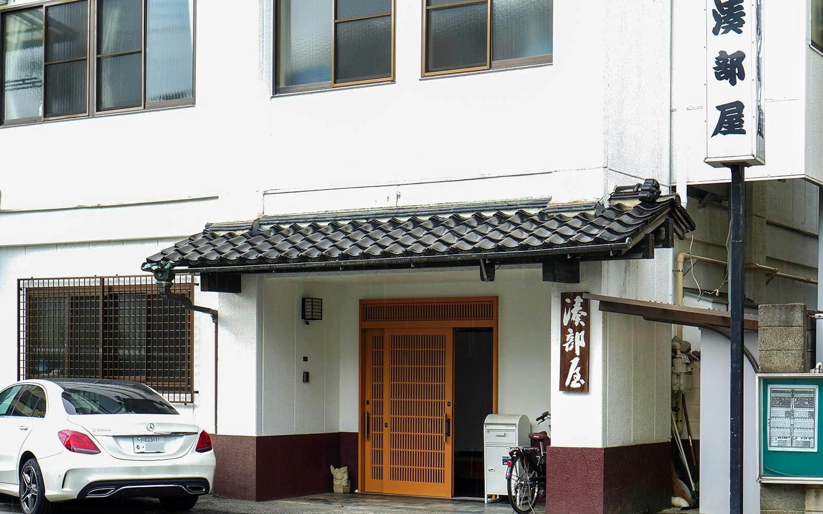 Entrance to a sumo stable in Japan with traditional architecture.
