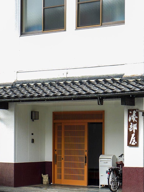 Entrance to a sumo stable in Japan with traditional architecture.