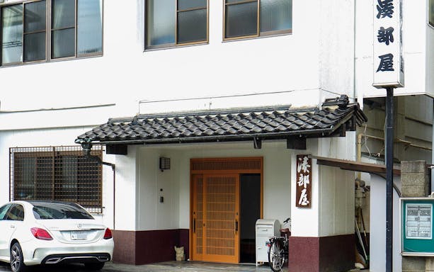 Entrance to a sumo stable in Japan with traditional architecture.