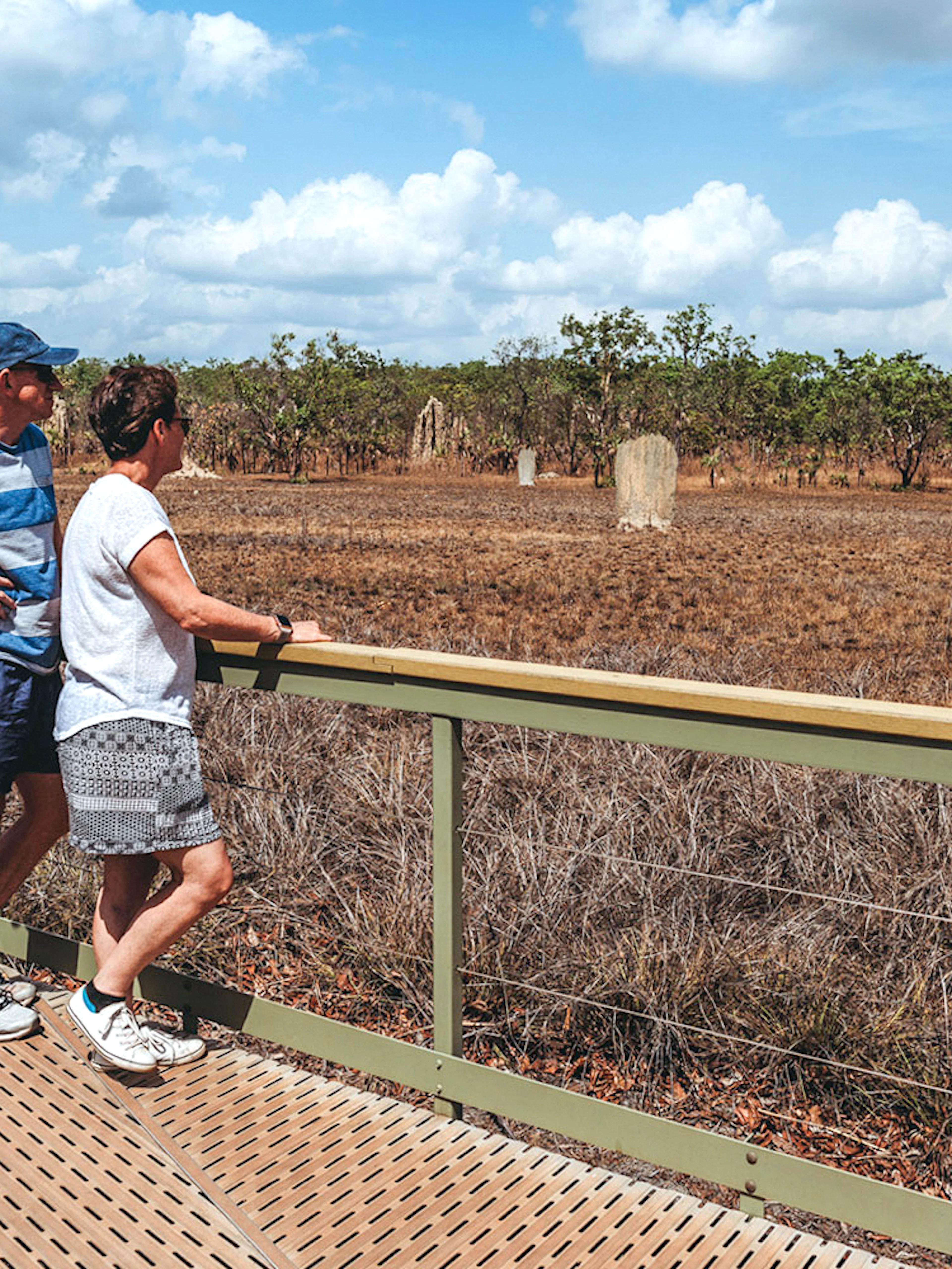 Visitors observing termite mounds at Litchfield National Park, Australia.