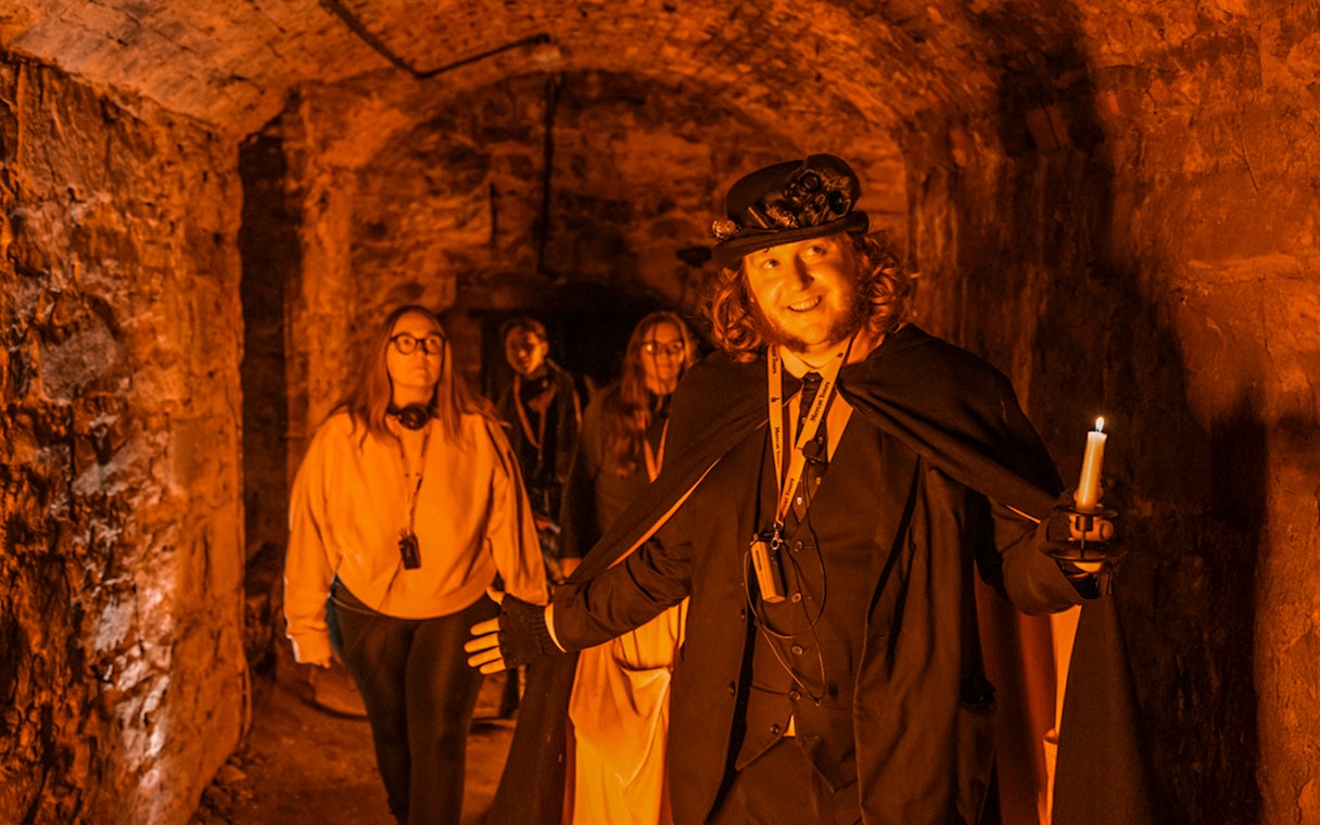 Tour guide leading a group through Blair Street Underground Vaults.