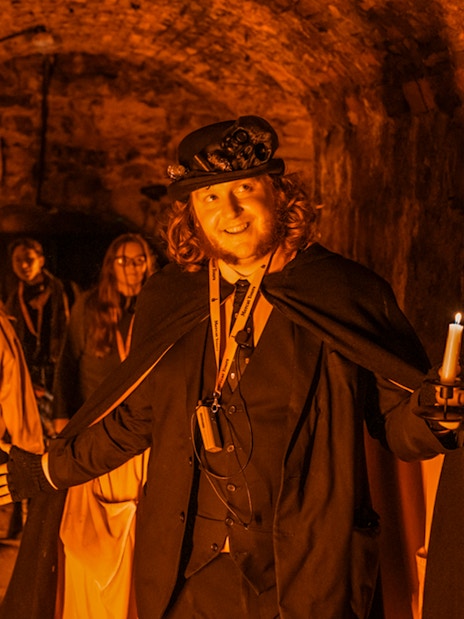 Tour guide leading a group through Blair Street Underground Vaults.
