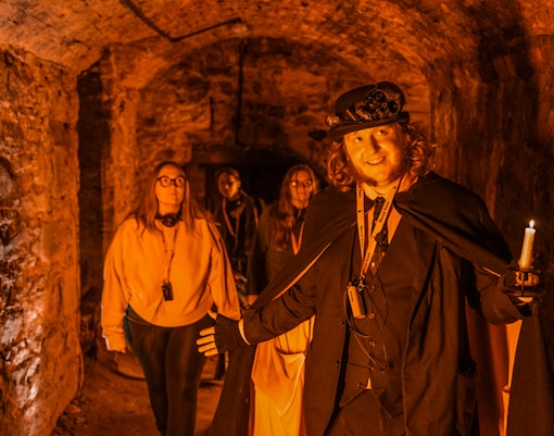 Tour guide leading a group through Blair Street Underground Vaults.