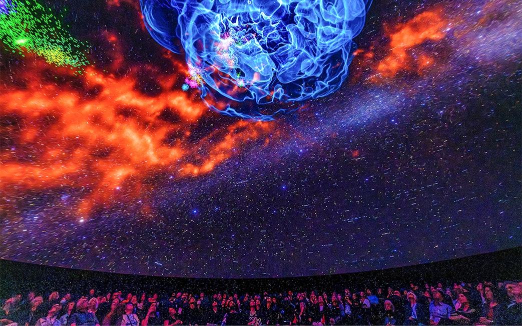 Visitors viewing cosmic display at Encounters in the Milky Way exhibit, American Museum of Natural History.