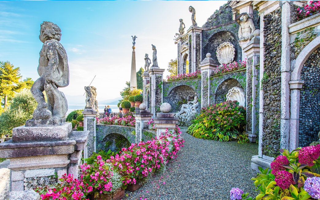 Statues and gardens at Isola Bella, Italy, with lake view in background.