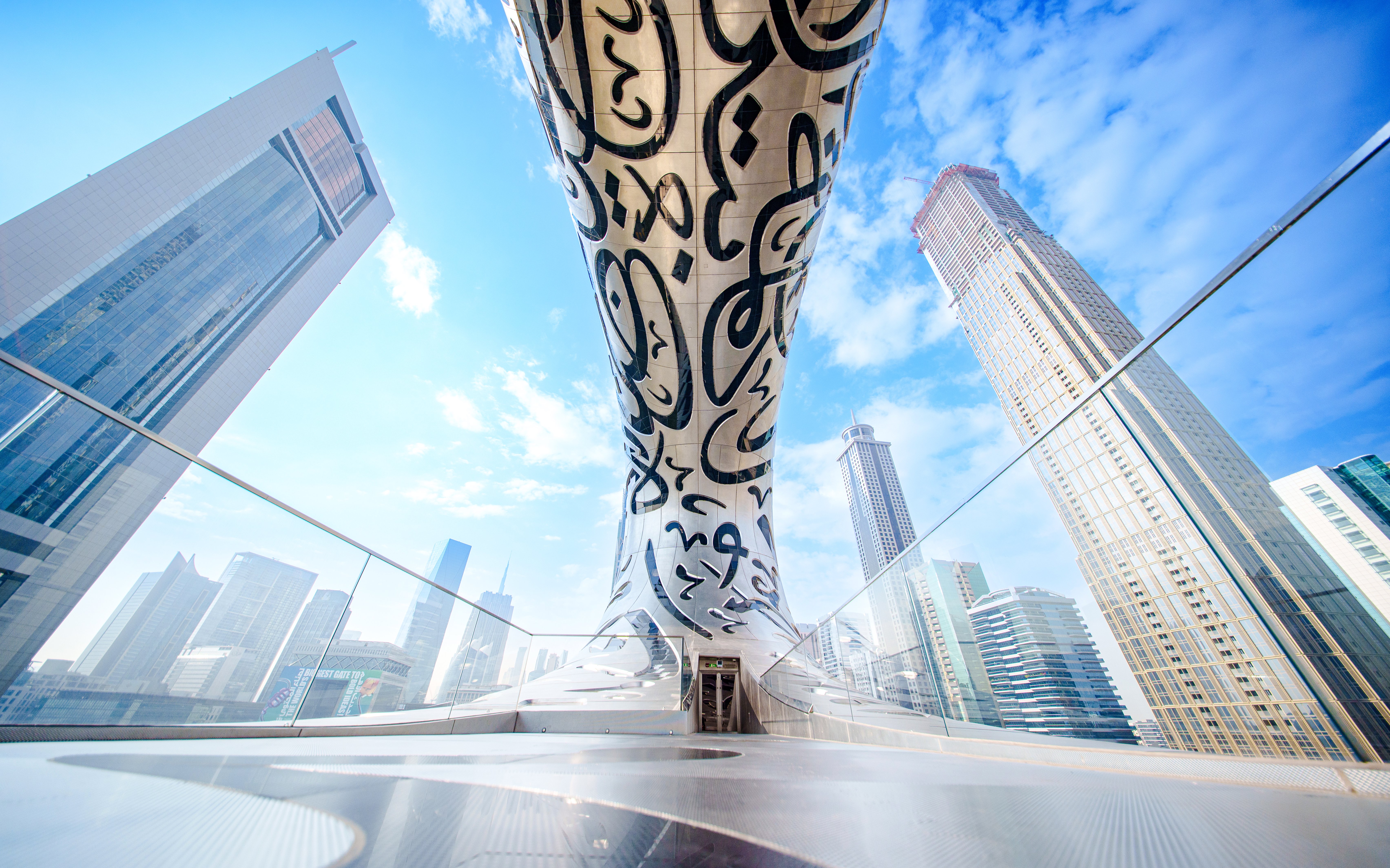 Futuristic architecture of the Museum of the Future in Dubai with surrounding skyscrapers.
