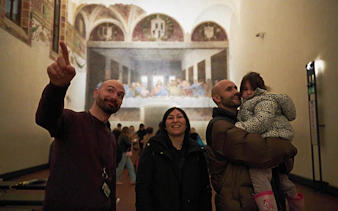 Visitors at Milan's Last Supper museum viewing the famous mural.
