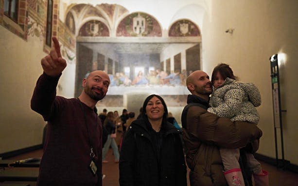 Visitors at Milan's Last Supper museum viewing the famous mural.