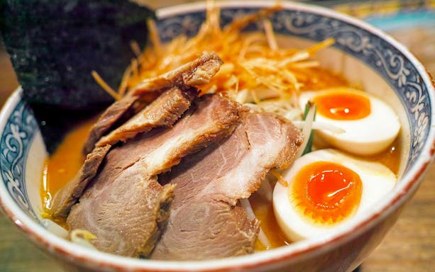 Bowl of ramen with sliced pork, soft-boiled eggs, and seaweed on the Tokyo Ultimate Ramen Tasting Tour.