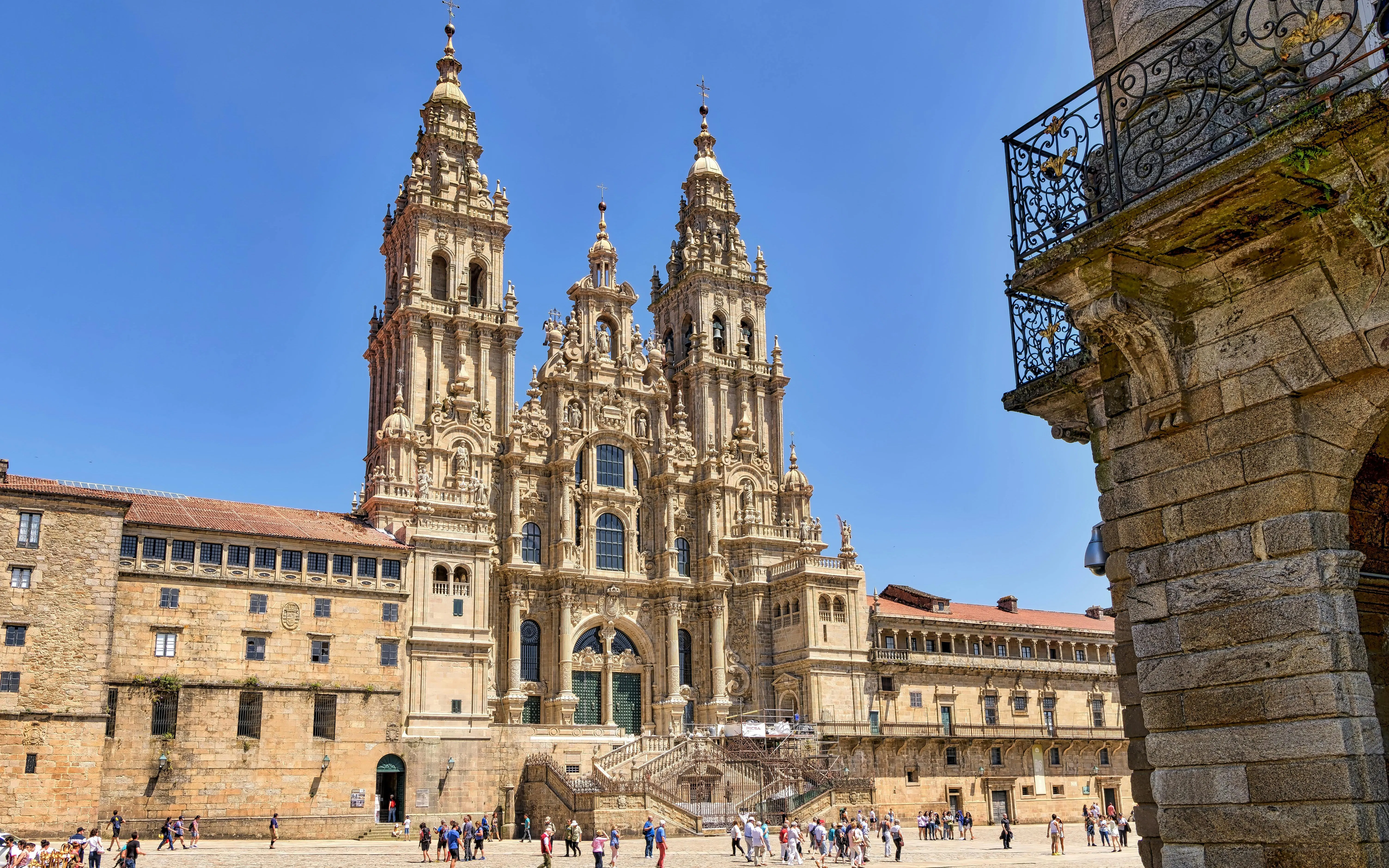 Santiago De Compostela Cathedral in Obradoiro Square with visitors exploring.