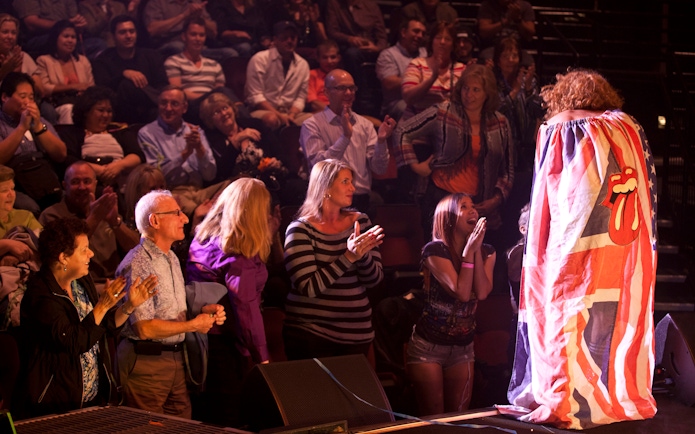Audience applauding during Carrot Top performance in Vegas show.