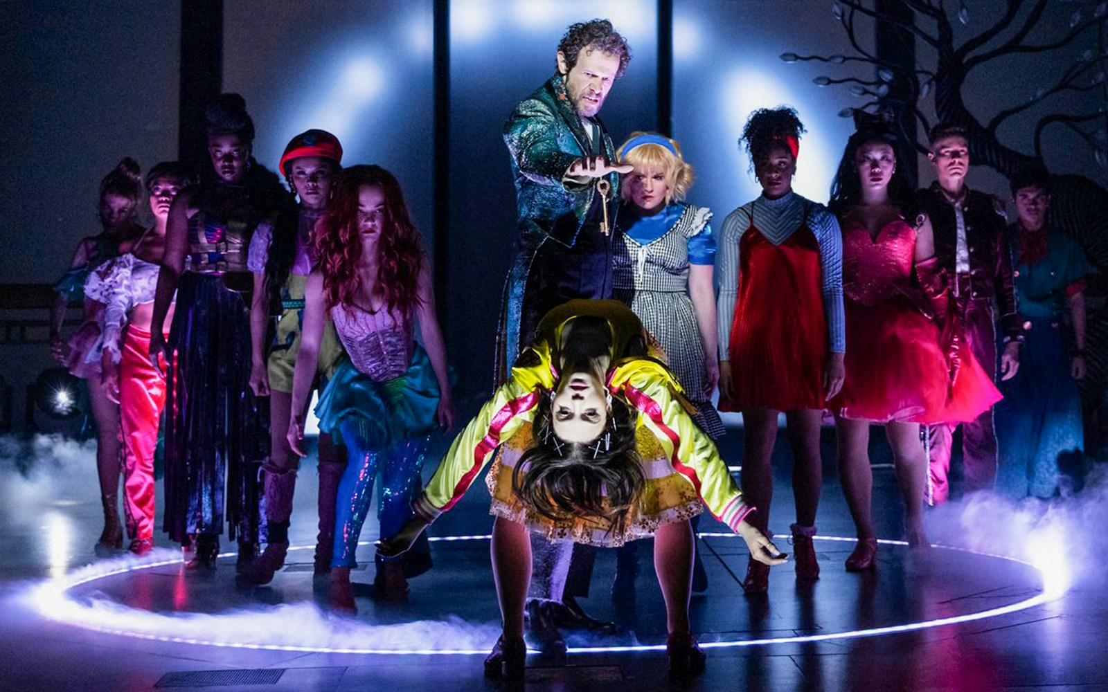 Performers on stage during "Once Upon a One More Time" show, featuring dramatic lighting and costumes.