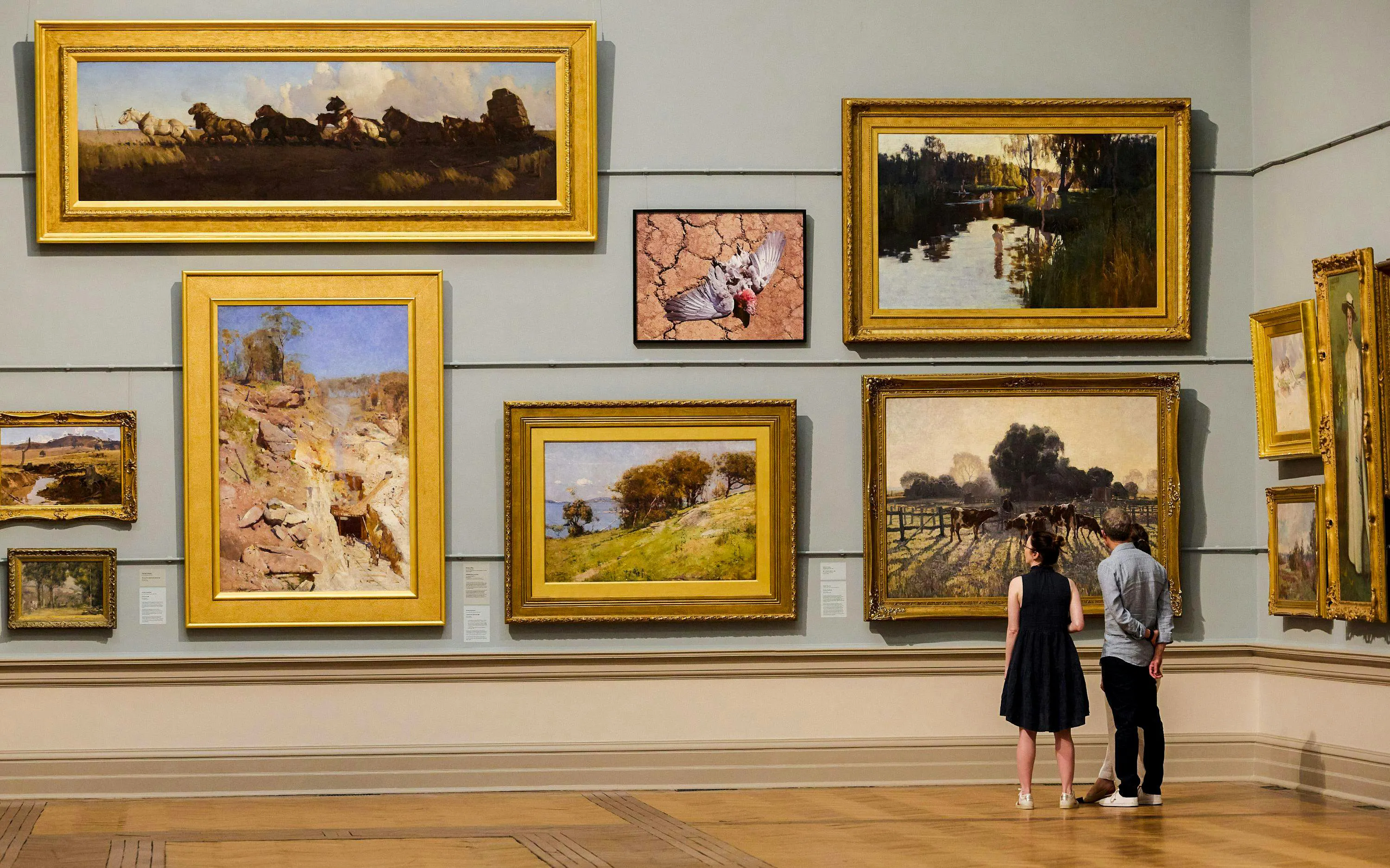 Visitors admiring paintings at the Art Gallery of New South Wales.