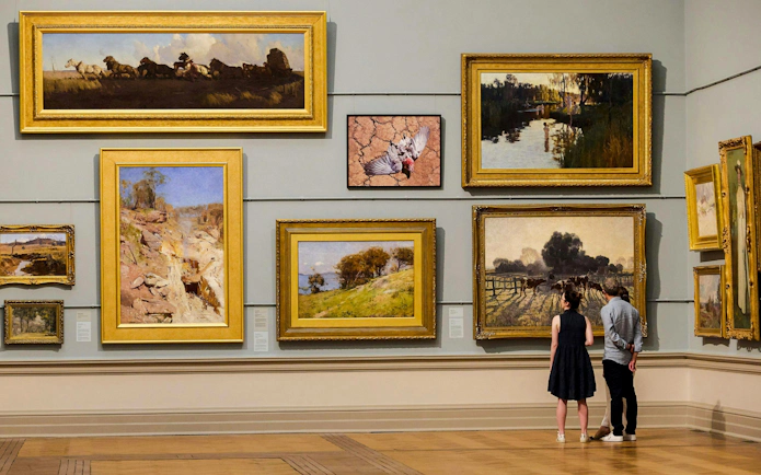 Visitors admiring paintings at the Art Gallery of New South Wales.