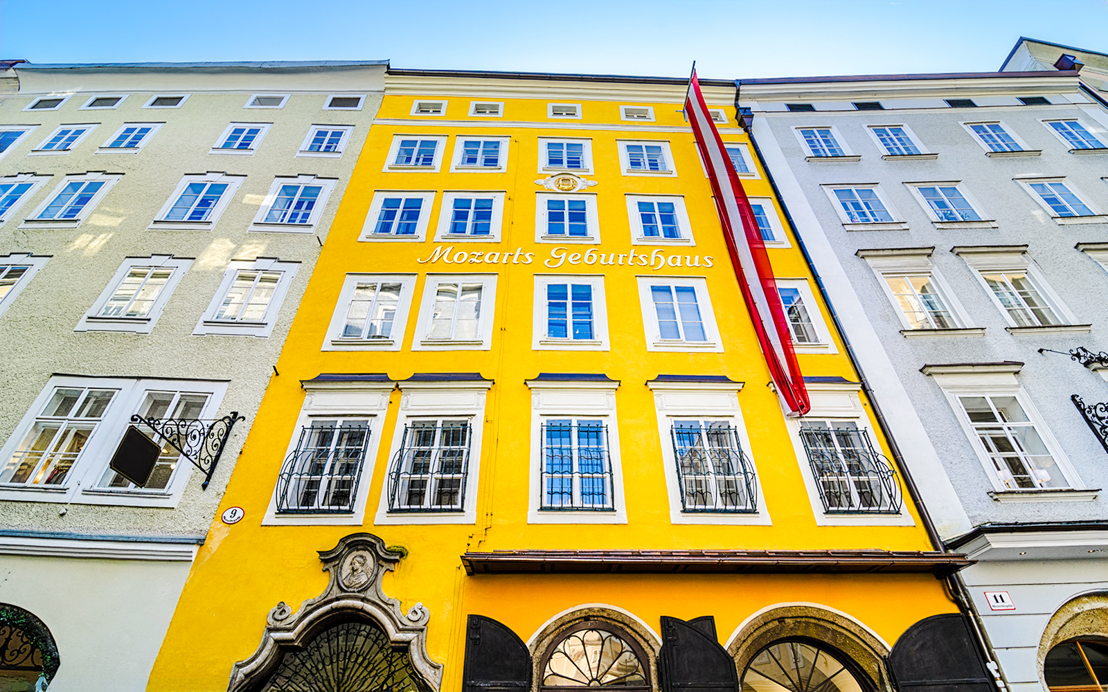 Birthplace of Mozart, yellow building facade in Salzburg, Austria.