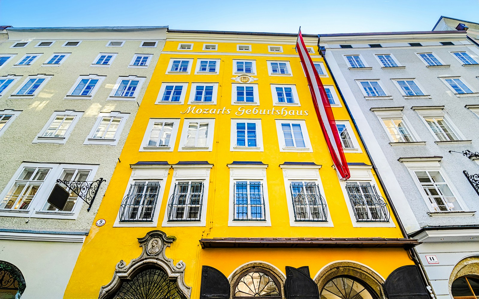 Birthplace of Mozart, yellow building facade in Salzburg, Austria.