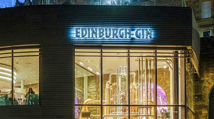 Edinburgh Gin distillery exterior with copper stills visible through glass.