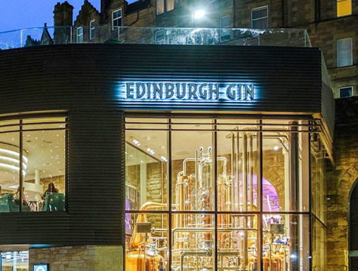Edinburgh Gin distillery exterior with copper stills visible through glass.