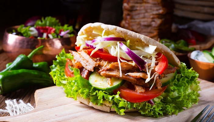 Miznon restaurant interior at Edge NYC with diners enjoying meals.