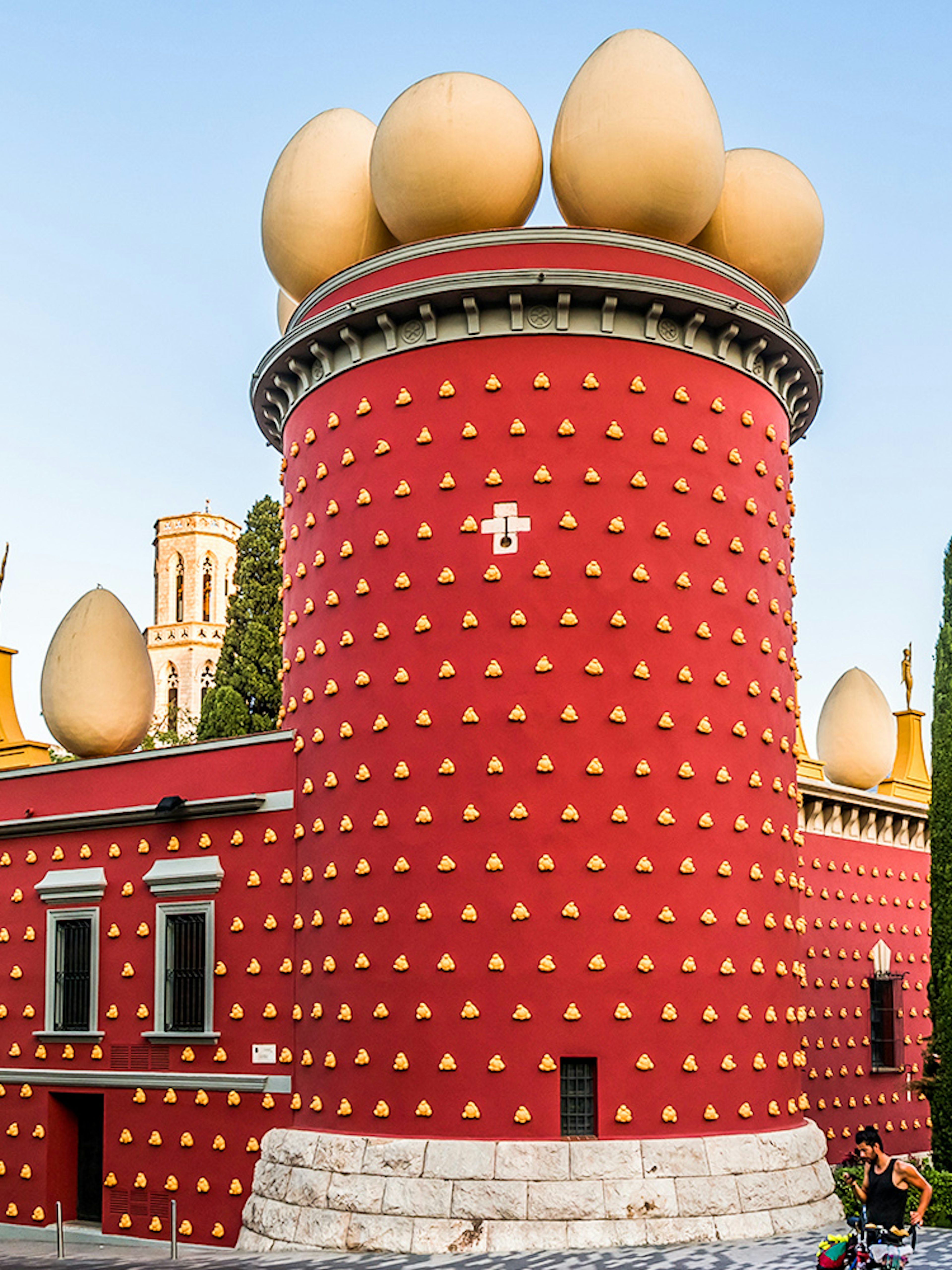 Dalí Theatre-Museum with egg sculptures on red facade in Figueres, Spain.