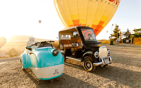 Trike and hot air balloon in Cappadocia valley during guided tour.