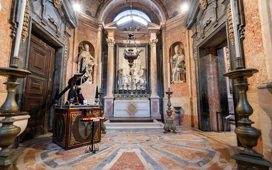 Altar inside the National Palace of Mafra with ornate sculptures and decorative elements.