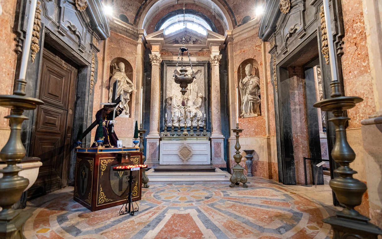 Altar inside the National Palace of Mafra with ornate sculptures and decorative elements.